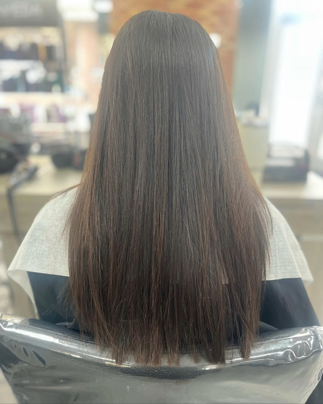 curled mid length hair after a brunette balayage hair colour make over at gavin ashley hairdressing salon in bury st edmunds 
